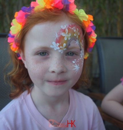 A HK face painter draw a rainbow face paint for a rainbow themed summer party