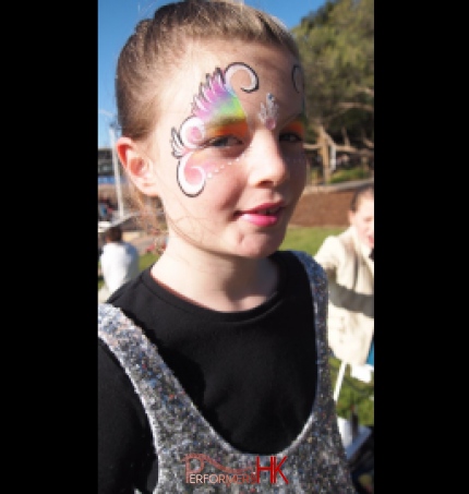 Lovely rainbow face paint form a great face painter in HK at a Hong Kong corporate funfair 