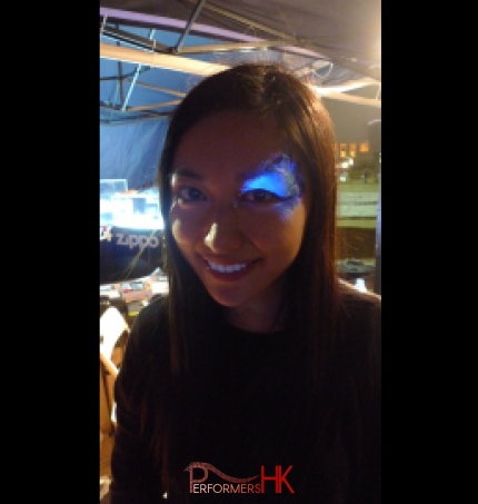 Girl with glow in the dark eye face paint.