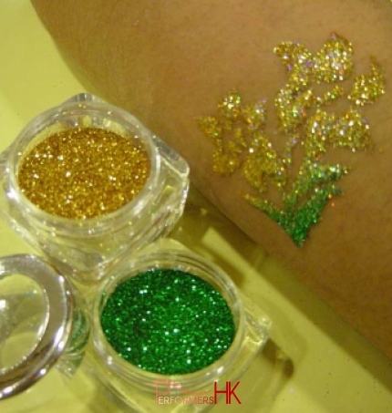 A yellow and green flower glittering tattoo by HK professional tattoo artist at kids function .