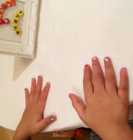 A little girl showing her new Hello Kitty nail art at a Birthday party in HK