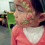 A Fancy flower face paint for a little girl.