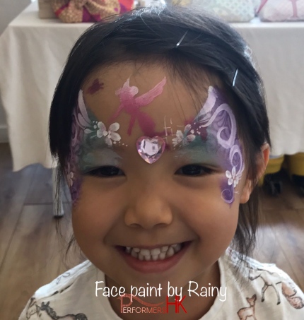 young girl with face painting by rainy