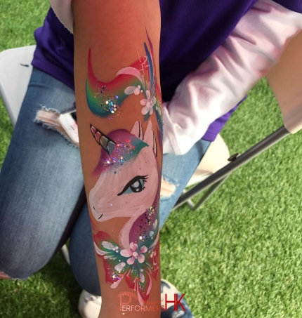 unicorn painted on arm of child