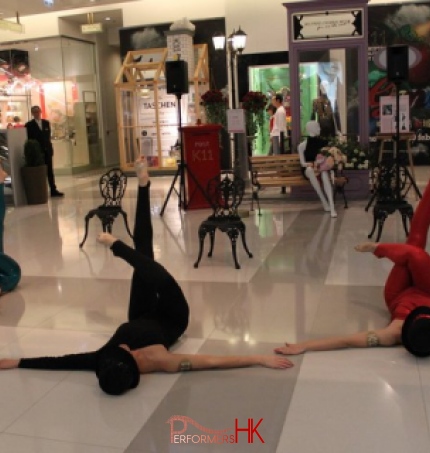 3 dancers on the floor of the shopping mall performing