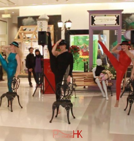 Modern dance performance in Hong Kong shopping mall with three dancers in hats