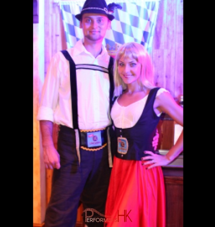 Bavarian dance duo poses at Jockey Club Oktoberfest event in Hong Kong