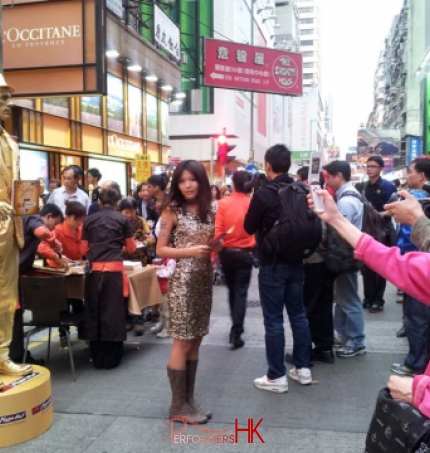 Promotion girl with Golden statue standing on box