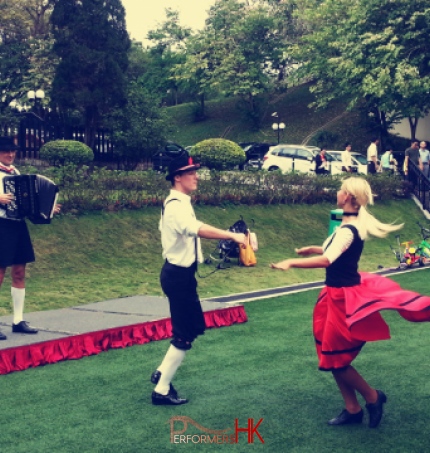 German dancing pair at a park in Hong Kong performing with music