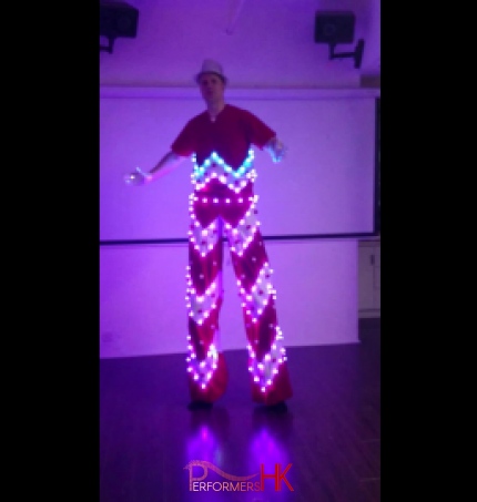 Stiltwalker in a LED costume posting at a studio in Hong Kong 