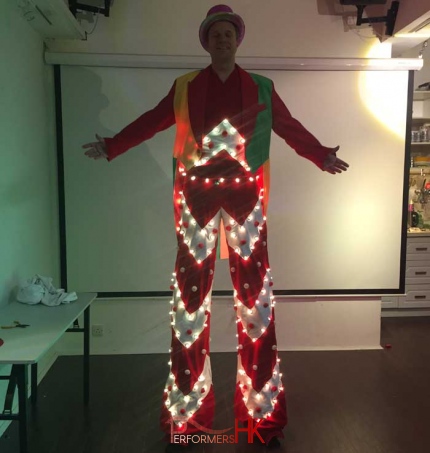 Hong Kong stilt-walker in HK wearing Clown jacket and LED stilt costume posing in front of the camera