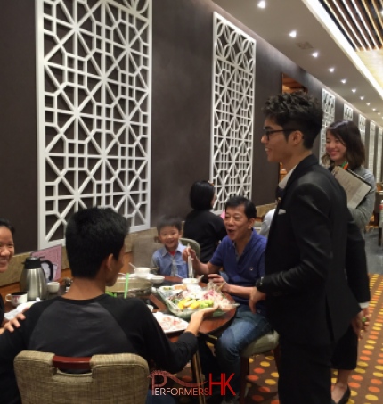 Magician in Hong Kong performing roving table magic for a family to promote the new menu at a restaurant 