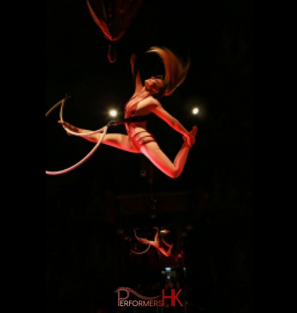 Aerial Solo Hoop performer during beautiful movement with the hoop in the midair at a corporate annual dinner.