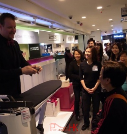 Magician performing roving card magic to customers at Sogo Hong Kong Hitachi product launch 