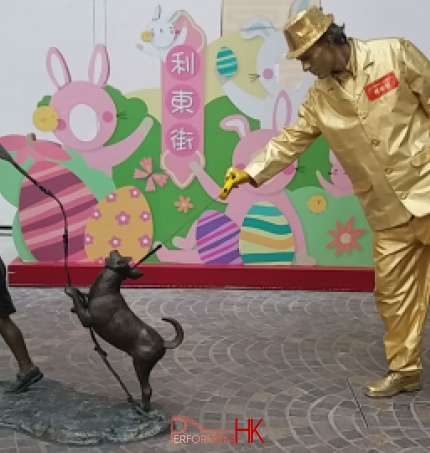 golden statue walking bronze statue dog