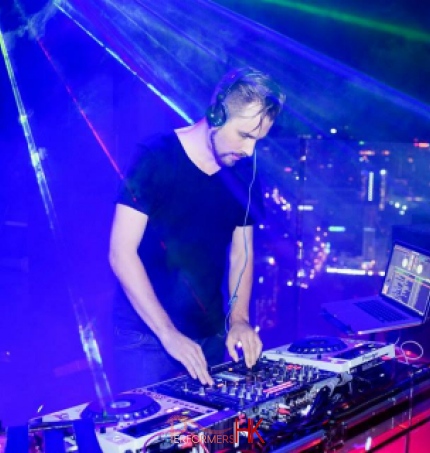 Professional DJ Pure MB makes music in Hong Kong under blue light