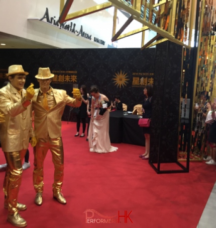 Three statues performers posing at a corporate event open ceremony 