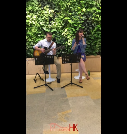 Singer and guitarist performing at Pacific place in Hong kong, casual summer vibe