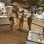 Ukulele trio performing at IFC supermarket