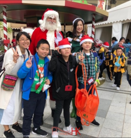 santa in hong kong with kids from an event, kids are in their casual clothing, charity event