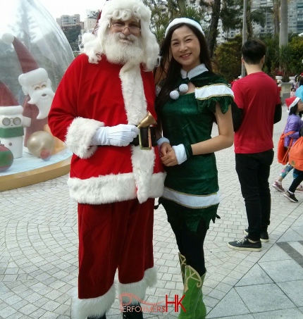 santa hong kong standing next to elf