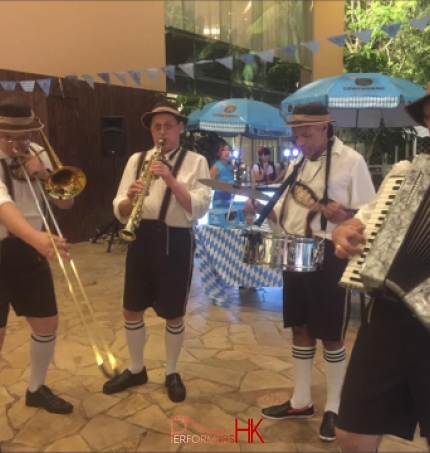 German band in full gear including clarinet, trombone, drums and accordion player