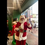 Santa Martin standing in front of shop window for Christmas 2022