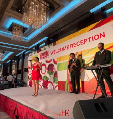 recently mentioned event by financial sec. of Hong Kong; Asia fruit logistica with singer and 2 musician on stage in black suit and red dress respectively