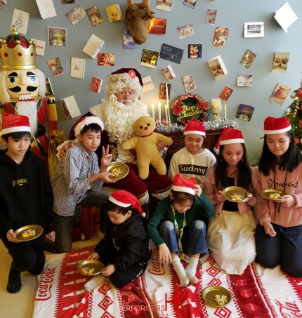 Mario Santa sitting with a bunch of kids at an event in hk for kids during Christmas time in Hong Kong shopping mall event