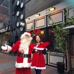 Santa Dave and Santa girl Kimmy in front of a resturant in Causeway Bay