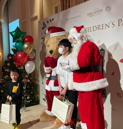 Santa on stage with Giant Teddy bear mascot with children holding gifts December Hong Kong Tsim Tsai Tsui, Penninsula Hotel group event