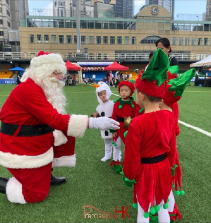 santa shaking hands with children in elf costume with snowman costume kids, greeting