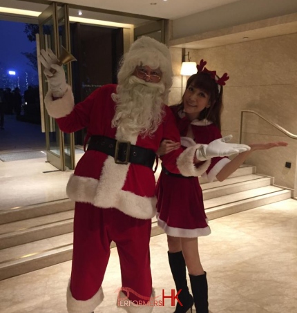 Santa in red costume with model heidi in santa girl costume at Kerry hotel for china light and power ltd. company cocktail event 