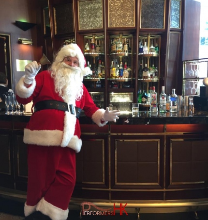 Santa in red costume, standing at the bar, waiting and greeting guests for event for Island Shangri La, Admiralty Hong Kong Dec 2023