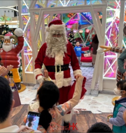 Santa performer in Hong Kong with Santa girl performer in red costume, greeting happy kids in Mira mall hong kong, tst, hong kong