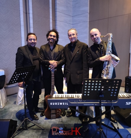 hk based jazz musicians ready to perform at event all dressed in black with keyboard, bass, sax and conga set up