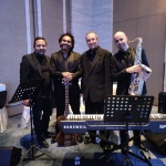 hk based jazz musicians ready to perform at event all dressed in black with keyboard, bass, sax and conga set up